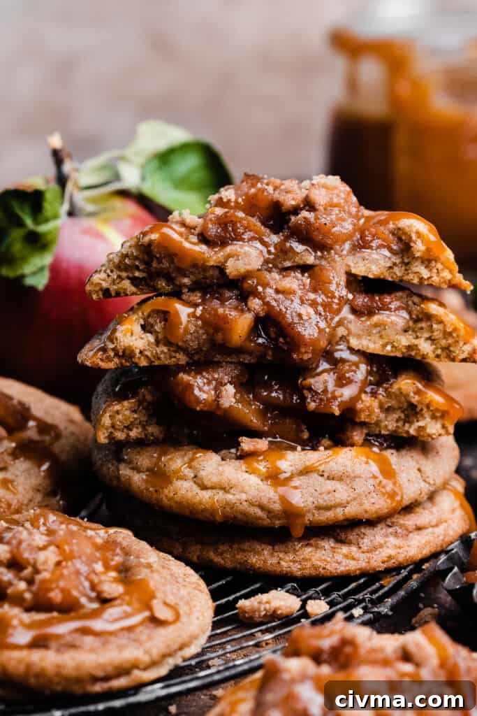 Salted Caramel Apple Pie Cookie Recipe 2 A stack of caramel apple pie cookies, with a few broken in half to show the insides.