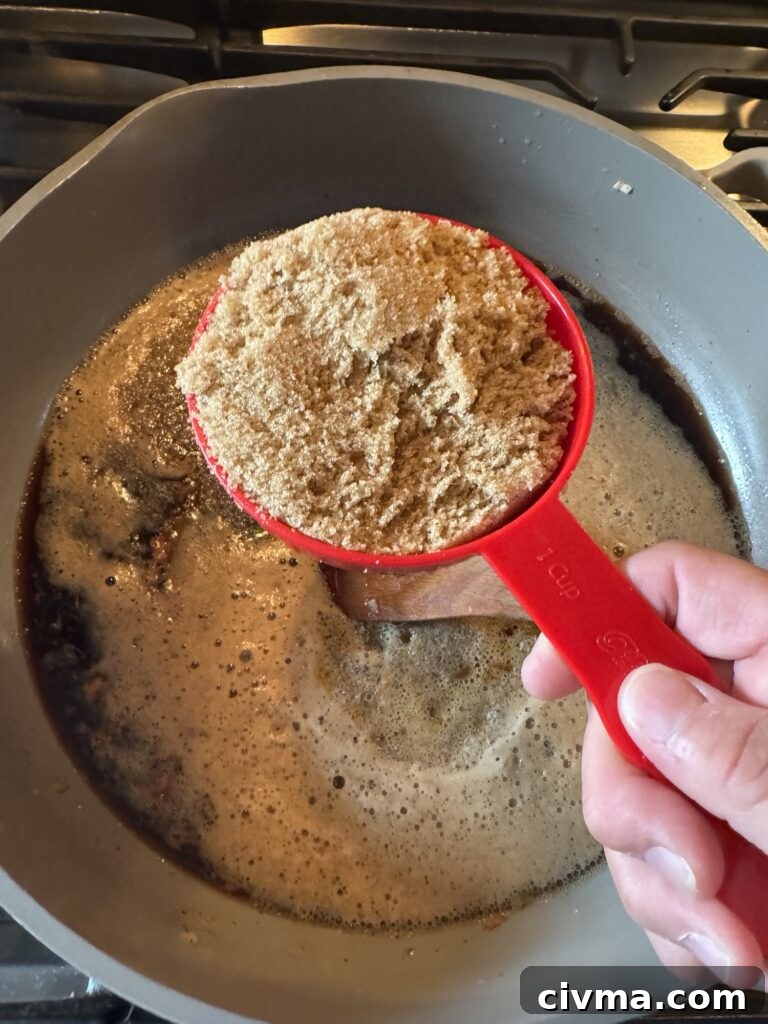 Guinness Dipping Sauce Recipe 4 A measuring cup of brown sugar over the Guinness sauce