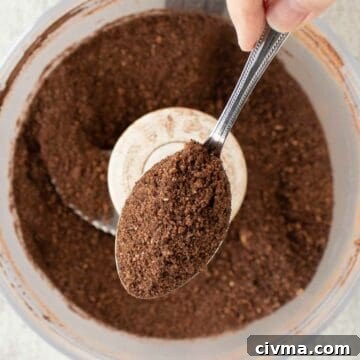 Bocconotti: Italian Chocolate-Almond Pastries from Puglia 7 Brown crumbly mixture in a spoon with more in food processor below.