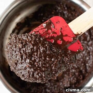Bocconotti: Italian Chocolate-Almond Pastries from Puglia 8 Brown shiny, coarse mixture on a red spatula.