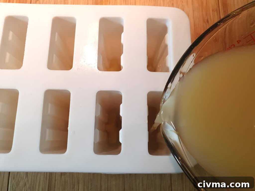 Filling popsicle moulds with popsicle mix.