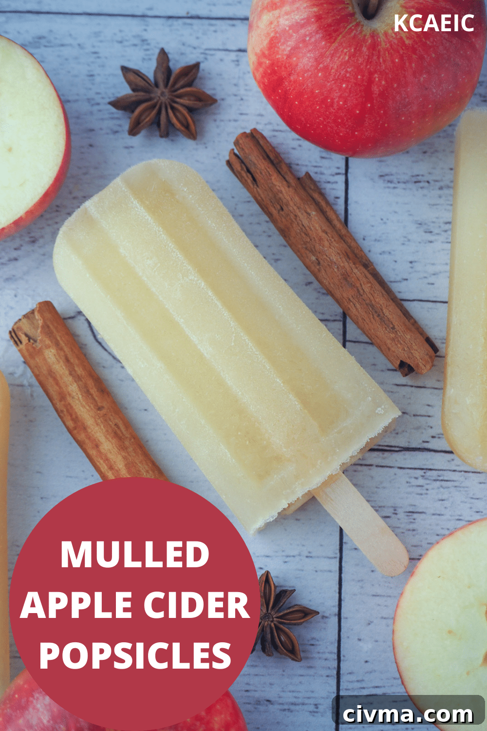 Top down view of mulled apple cider popsicle, with apple, apple star and star anise, with text overlay, mulled apple cider popsicles and KCAEIC.