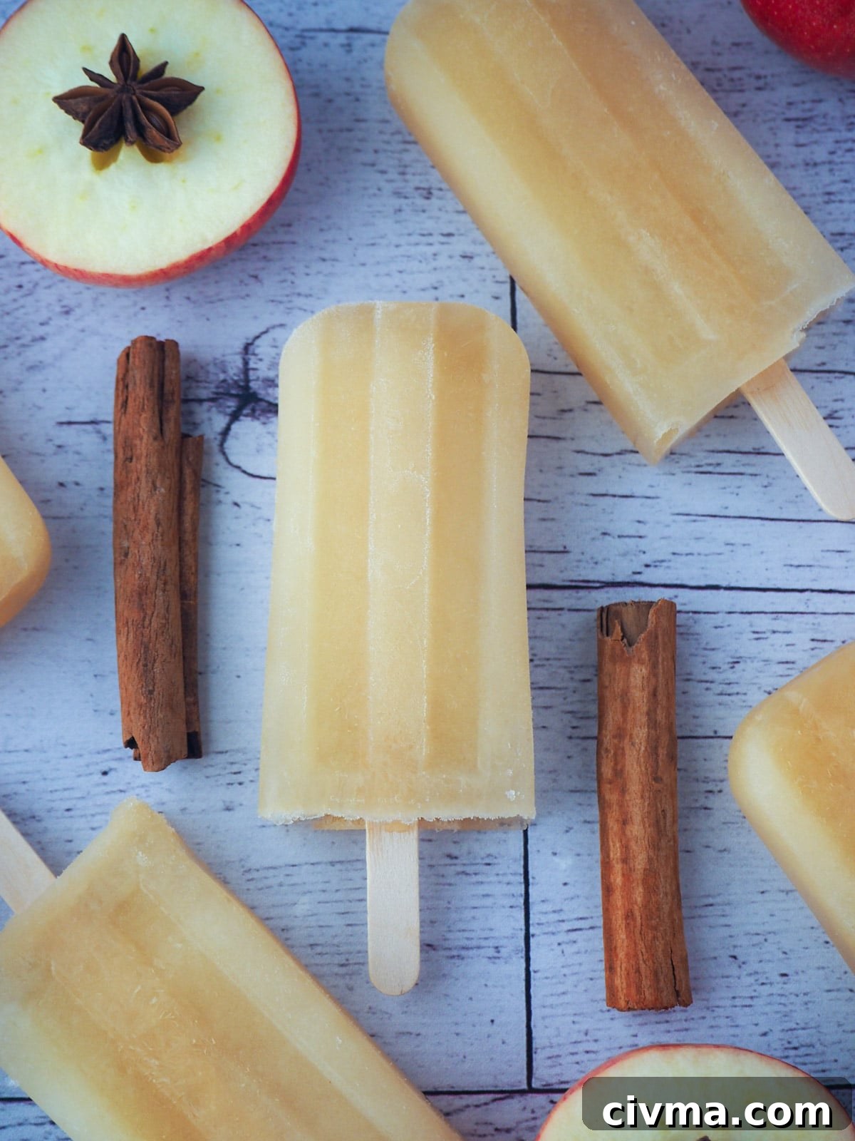 Apple cider popsicles with spices and fresh apples.