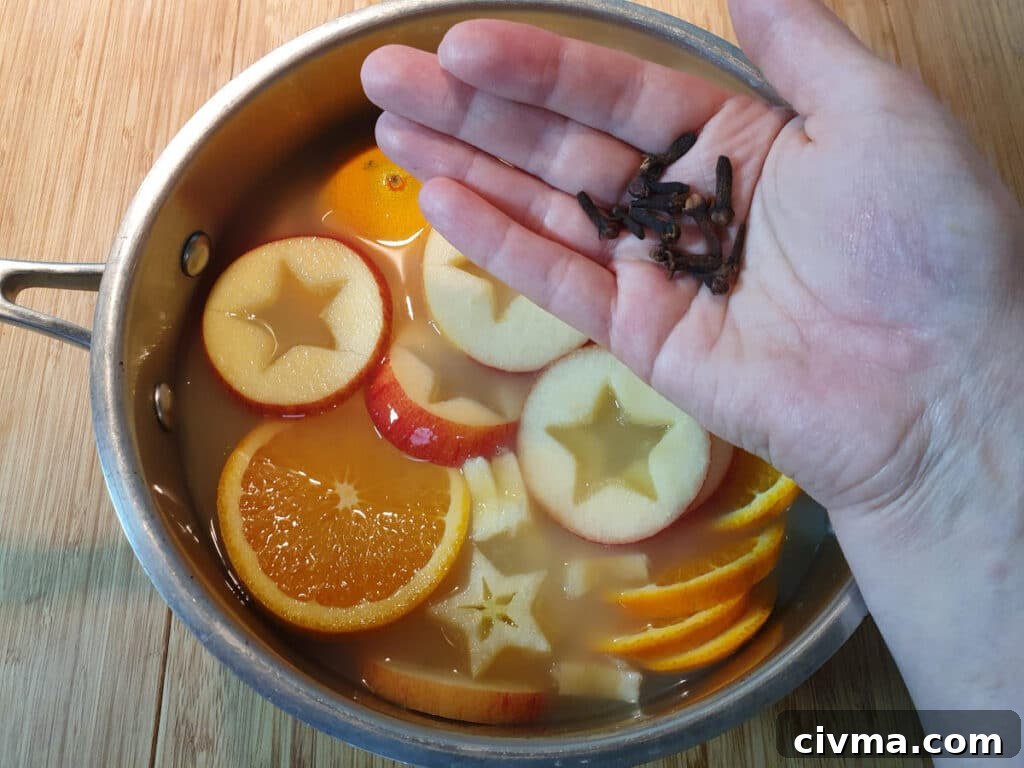 Adding whole cloves to the pot.