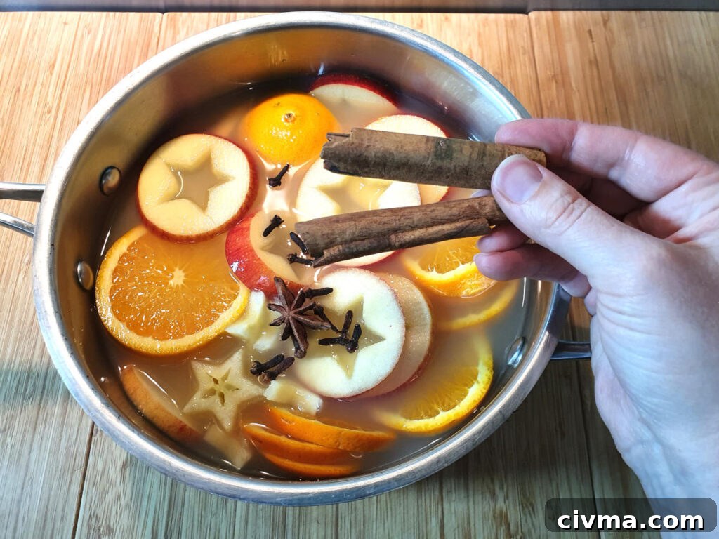Adding cinnamon sticks to pot.