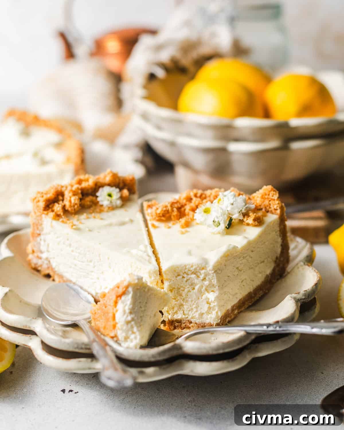 No Bake Lemon Icebox Pie with Graham Cracker Crust 3 sliced no bake lemon icebox pie on a plate with a spoon.