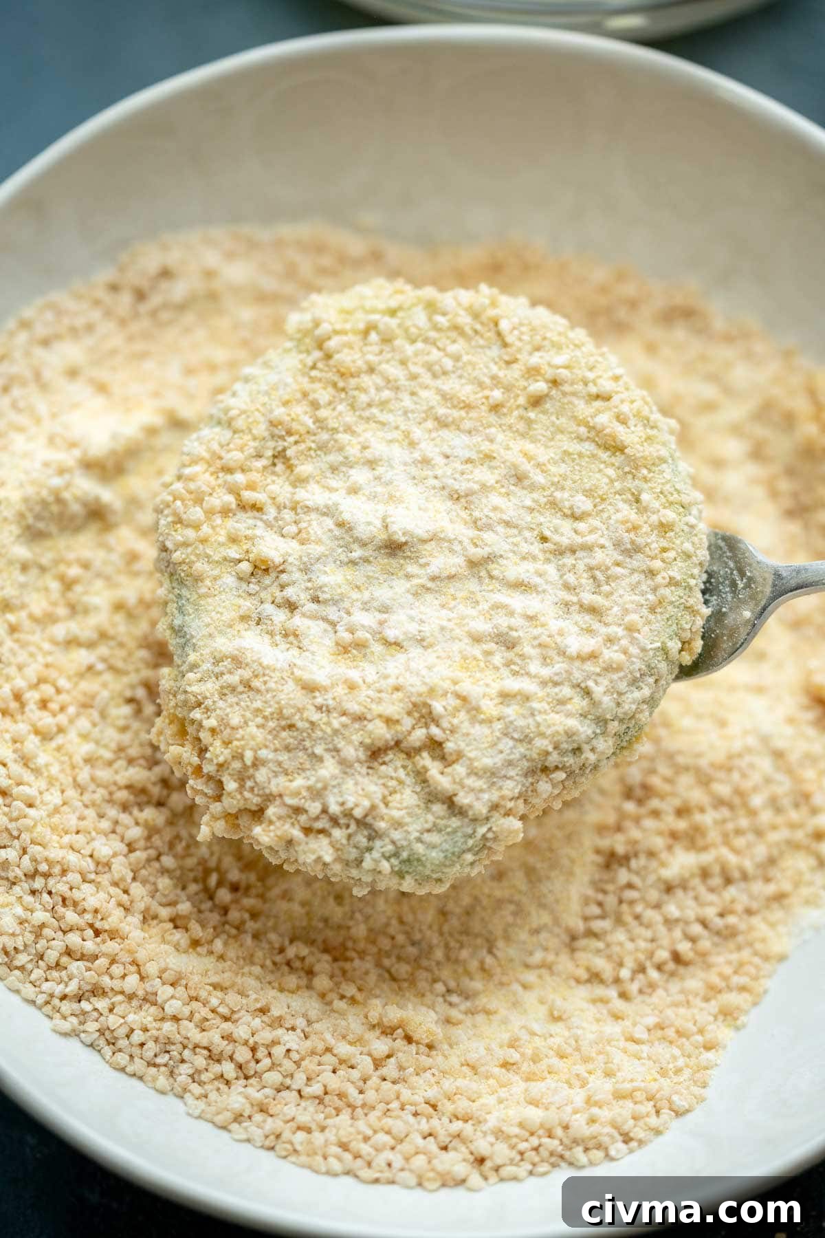 a green tomato slice covered in cornmeal breading