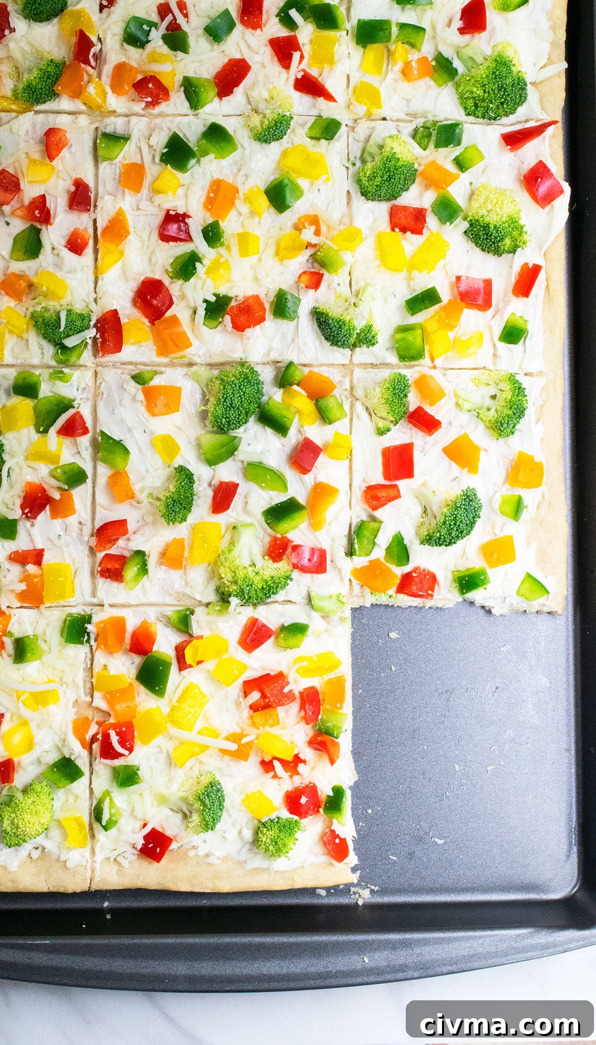 Sliced ranch pizza on nonstick baking tray.