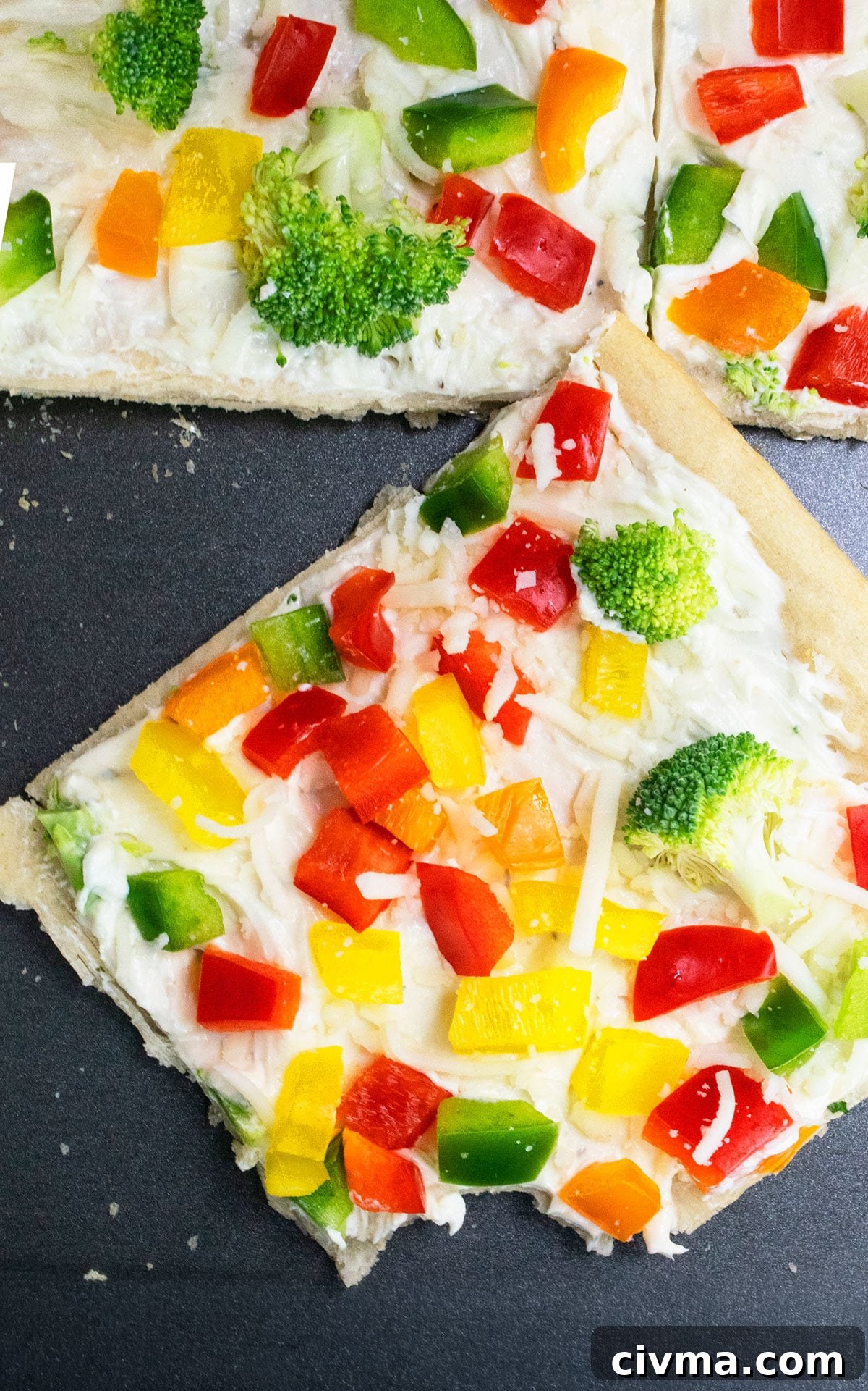 Slice of cold pizza on nonstick baking tray.