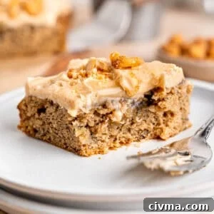 A slice of banana snack cake on a plate with a fork.
