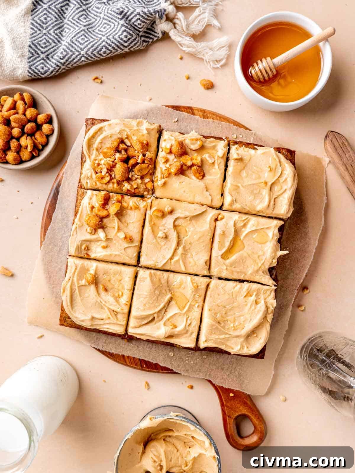 Top view of an 8x8 inch banana cake with frosting cut into 9 squares.