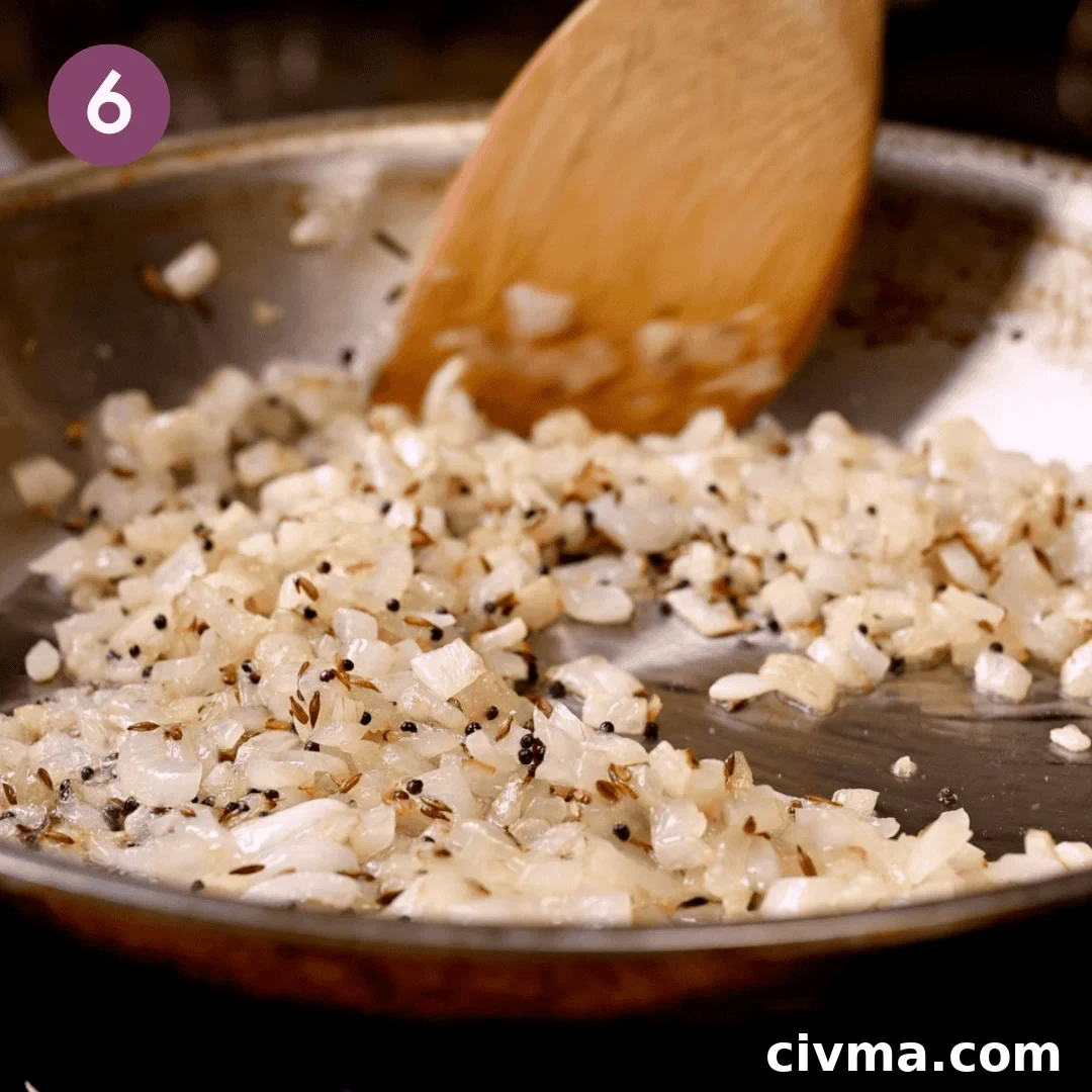 onions cooking with the cumin and mustard seeds.