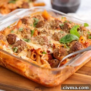 A casserole dish filled with pasta and meatballs.