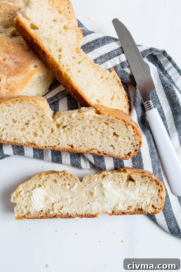 No Yeast Sourdough Bread sliced and spread with butter. 