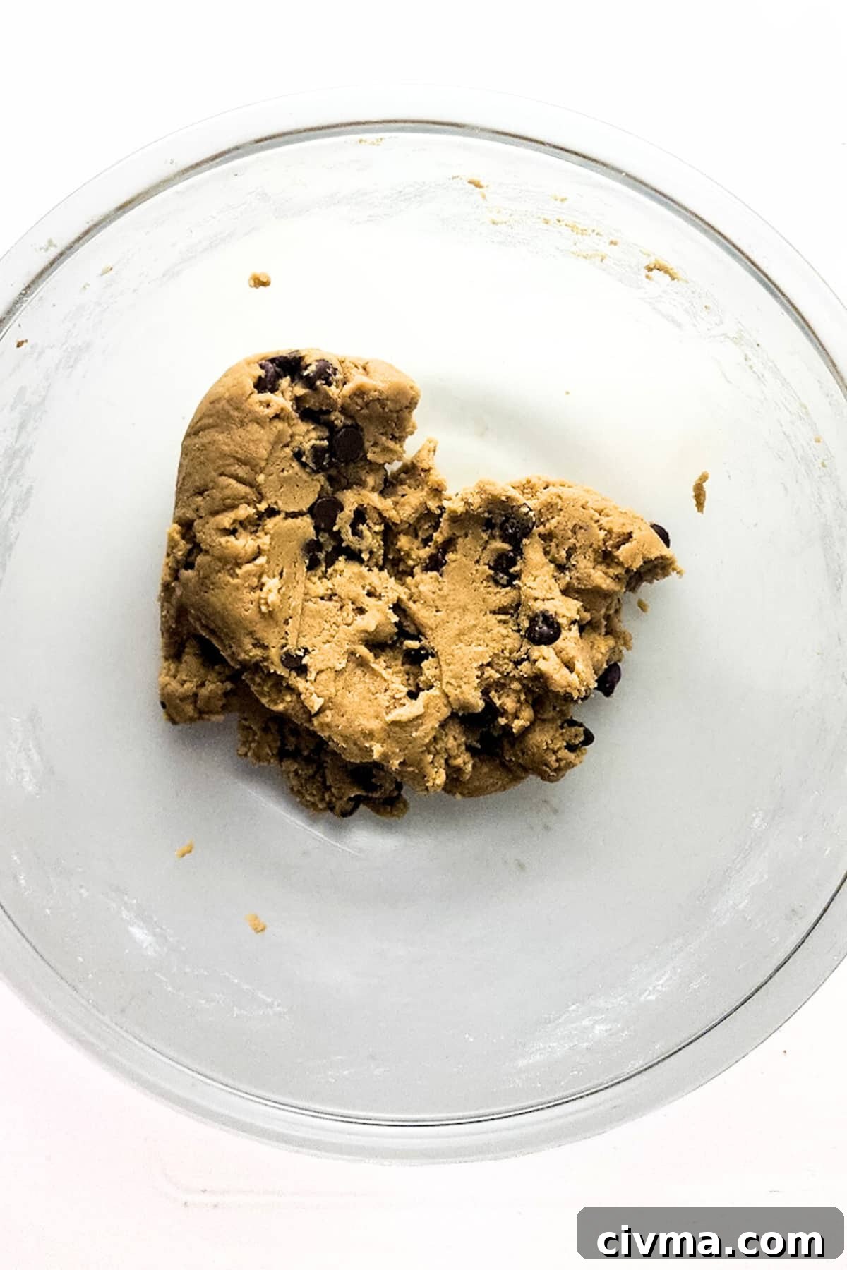 Chocolate chip cookie dough in glass bowl.