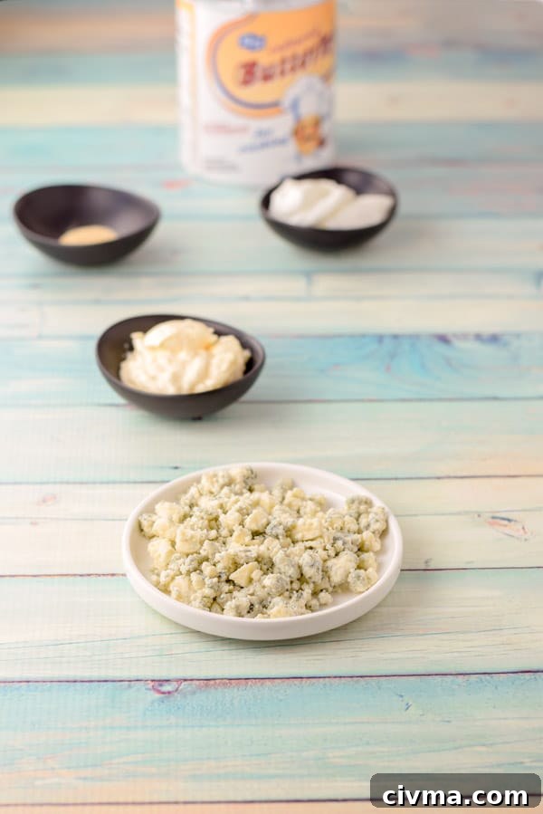 Blue cheese, sour cream, mayonnaise, spices and buttermilk on a green background