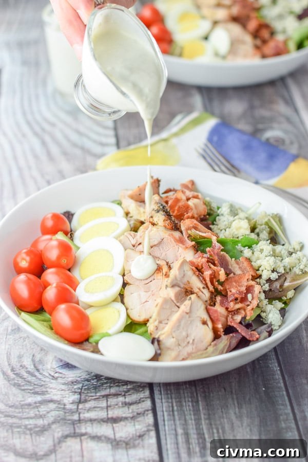 Pouring dressing on the easy delicious cobb salad