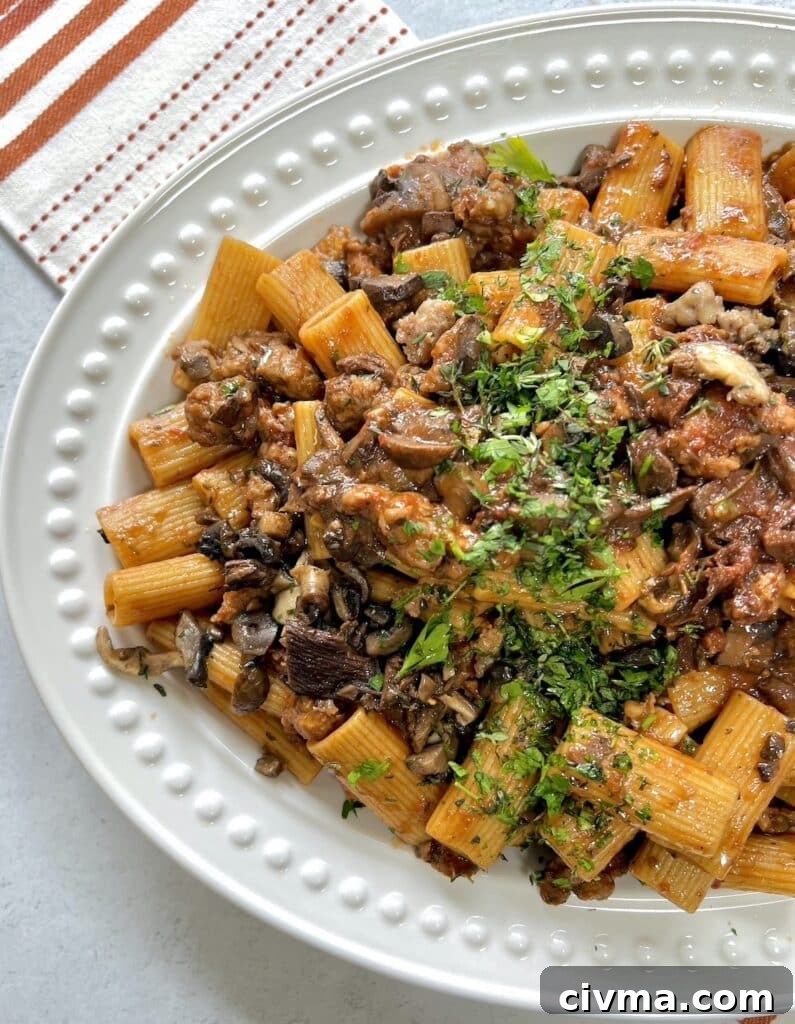Rigatoni Boscaiola Recipe: Creamy Mushrooms and Sausage 8 Overhead view of boscaiola pasta in white platter.