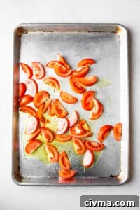 Roasted tomato wedges on a sheet pan