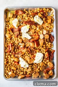 Chickpeas sausage and halloumi added to the sheet pan
