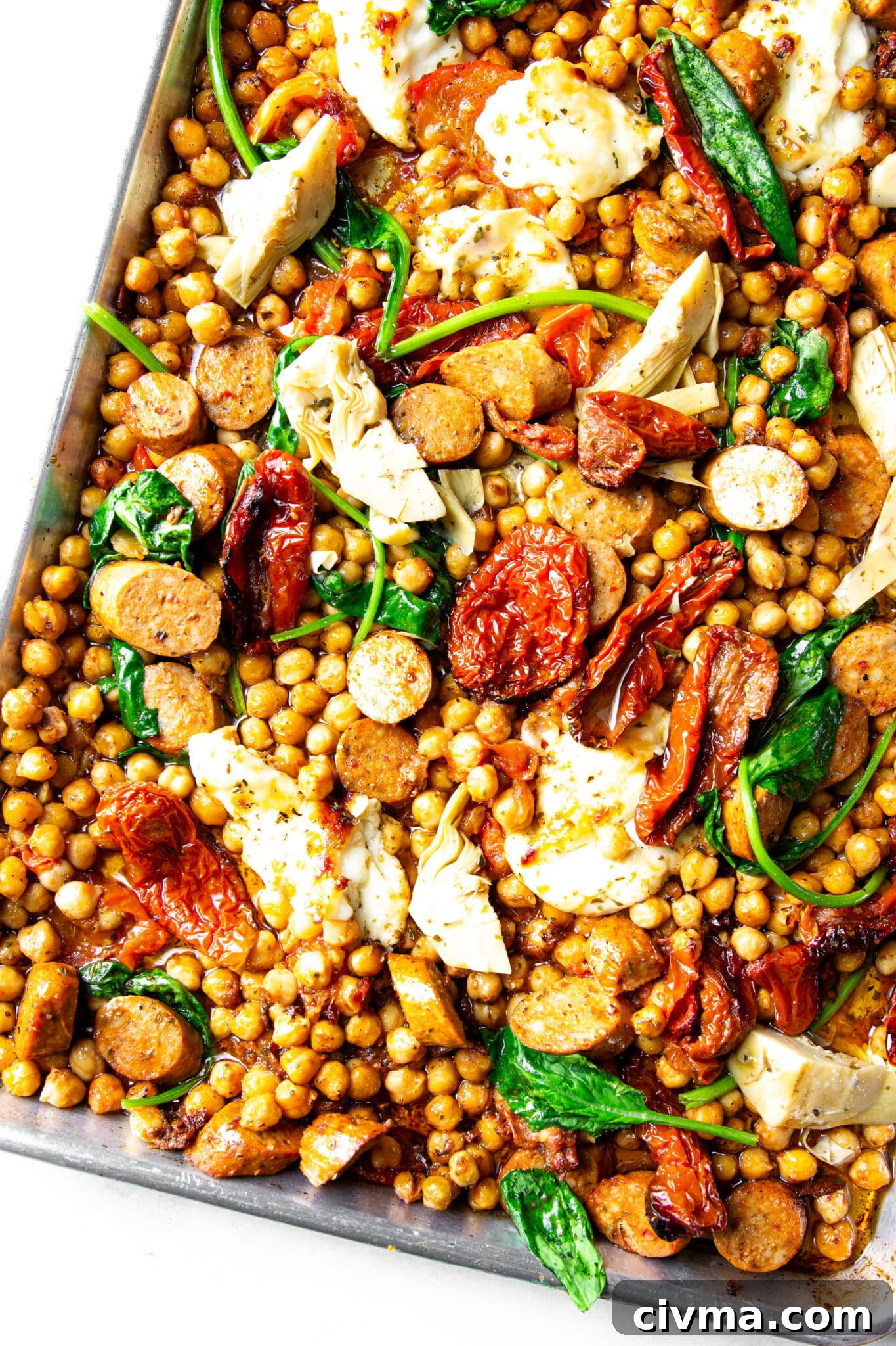 Sausage chickpeas halloumi and sun-dried tomatoes served warm