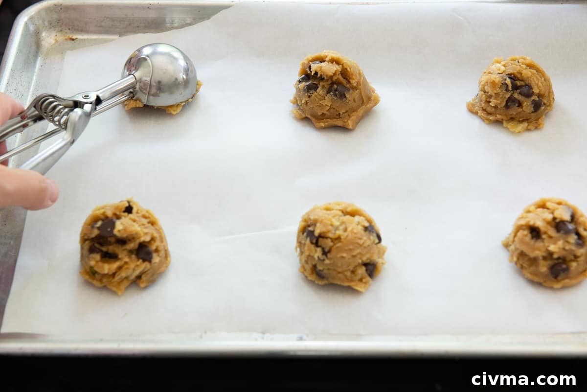 Scooping Potato Chip Cookie Dough Onto Parchment Paper with Cookie Scoop