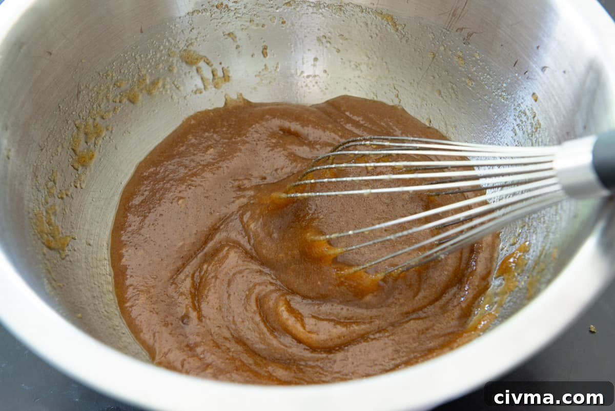 Whisking together the wet ingredients in a mixing bowl with whisk
