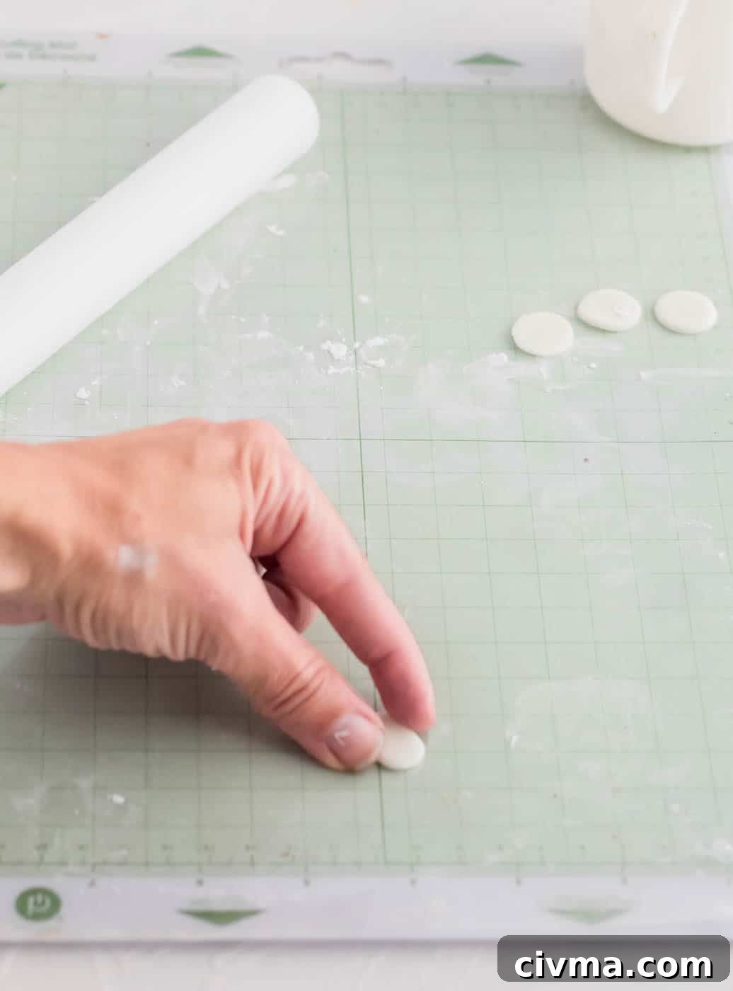 Shaping white fondant circles into oval eyes