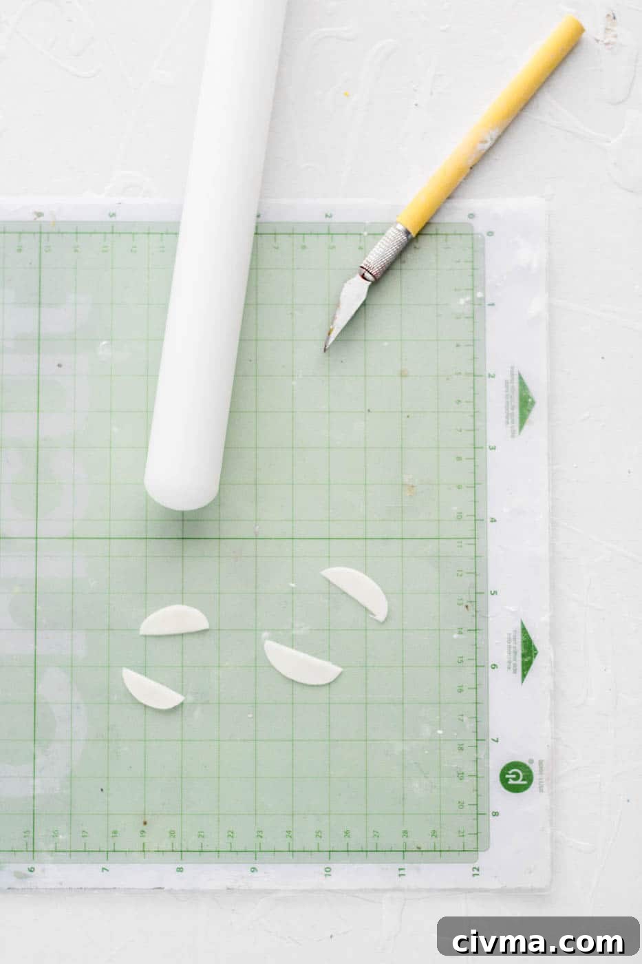 Making white fondant mouths for poop emoji cupcakes