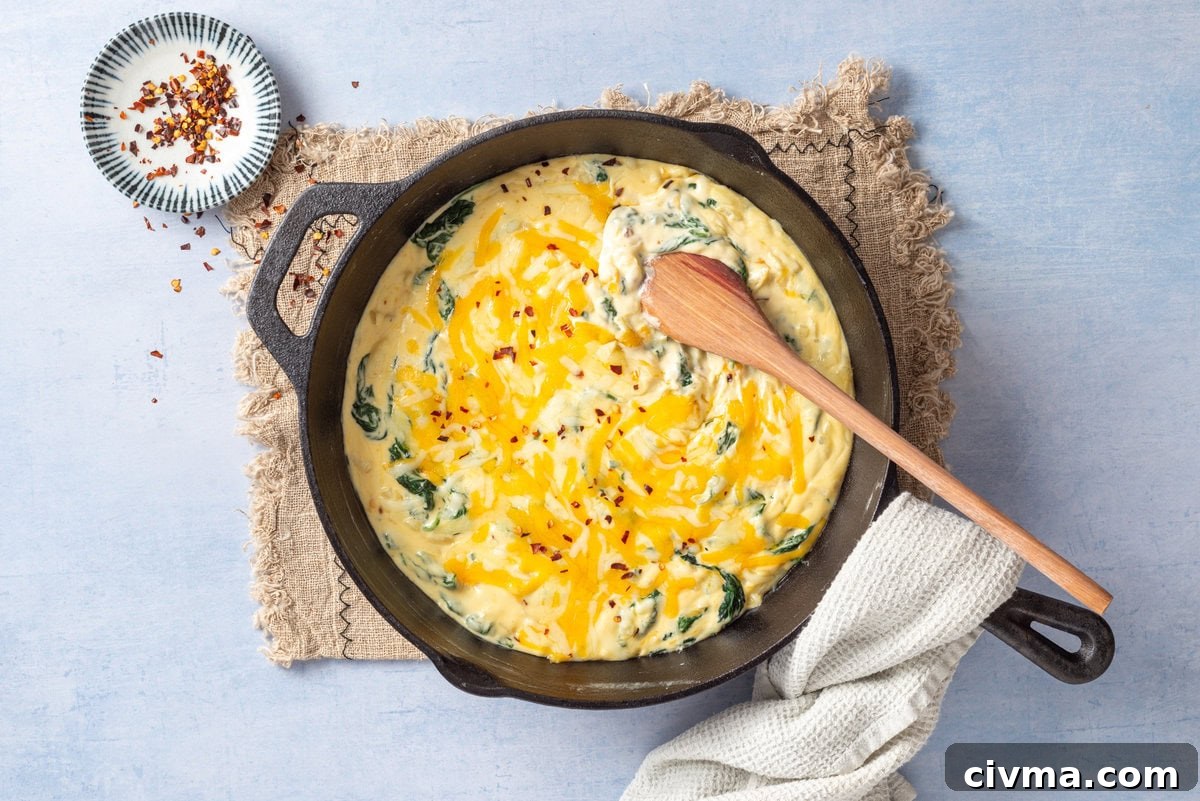 An image of creamed spinach in a skillet.