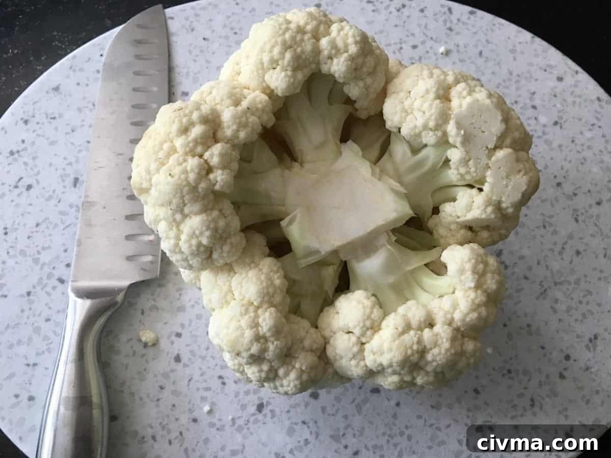 The stem and leaves removed from a head of cauliflower.