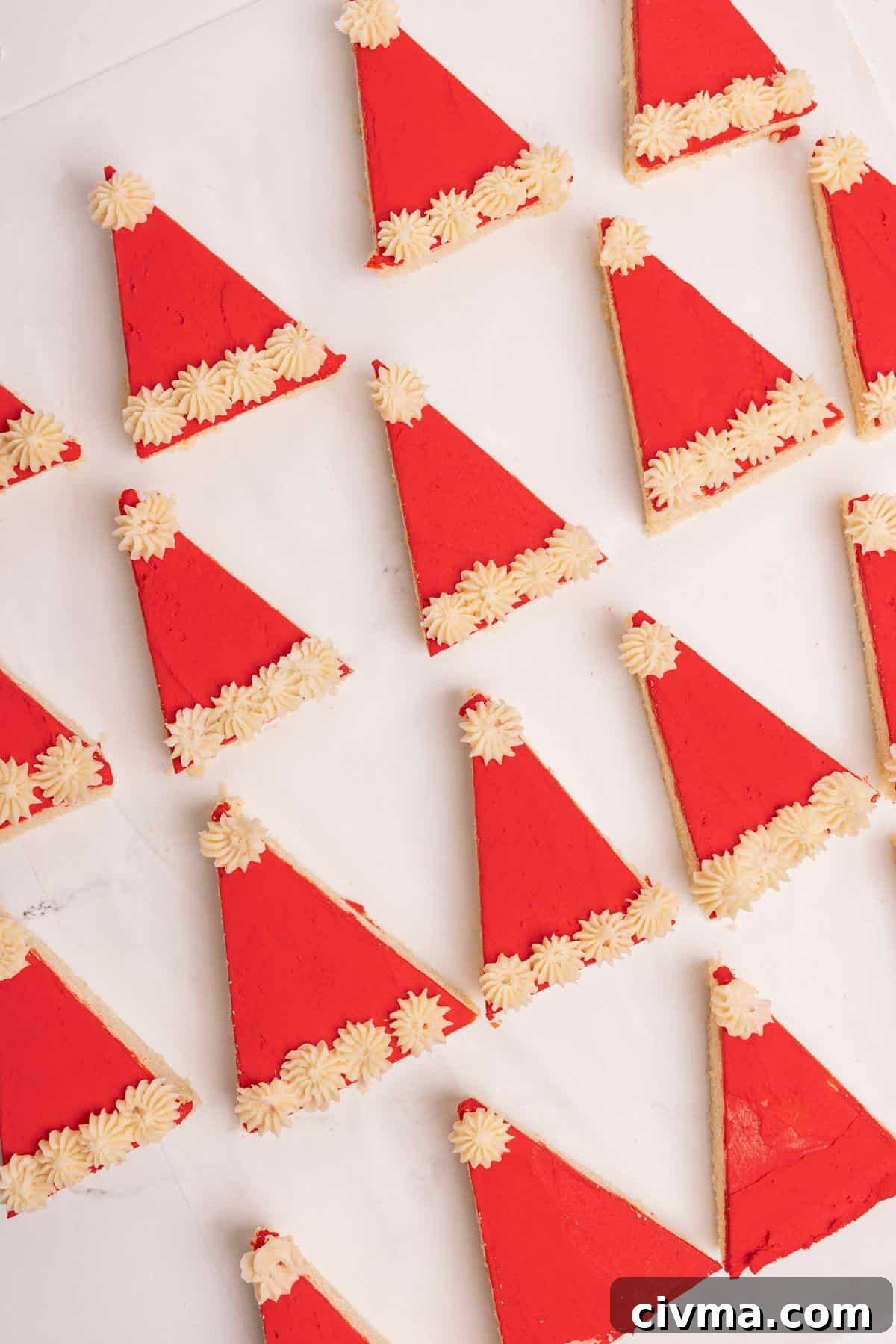 Santa Hat Sugar Cookie Bars for Christmas 2 santa hat sugar cookie bars decorated on parchment lined sheet