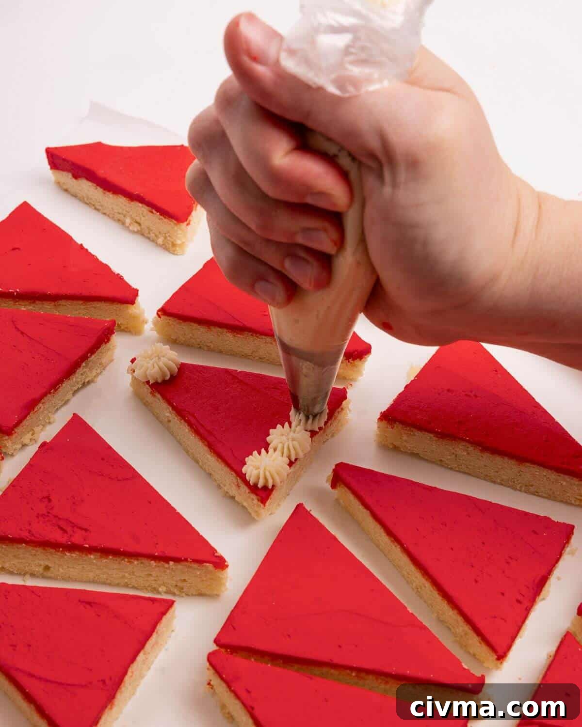 Santa Hat Sugar Cookie Bars for Christmas 11 adding white pompoms to red sugar cookie bars