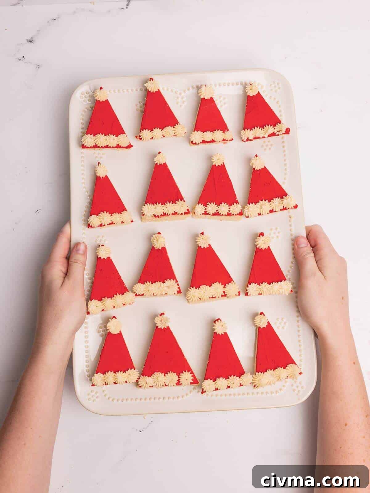 Santa Hat Sugar Cookie Bars for Christmas 12 santa hat sugar cookie bars on white serving tray