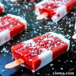 Red and white striped strawberry rhubarb coconut milk popsicles on a black background.