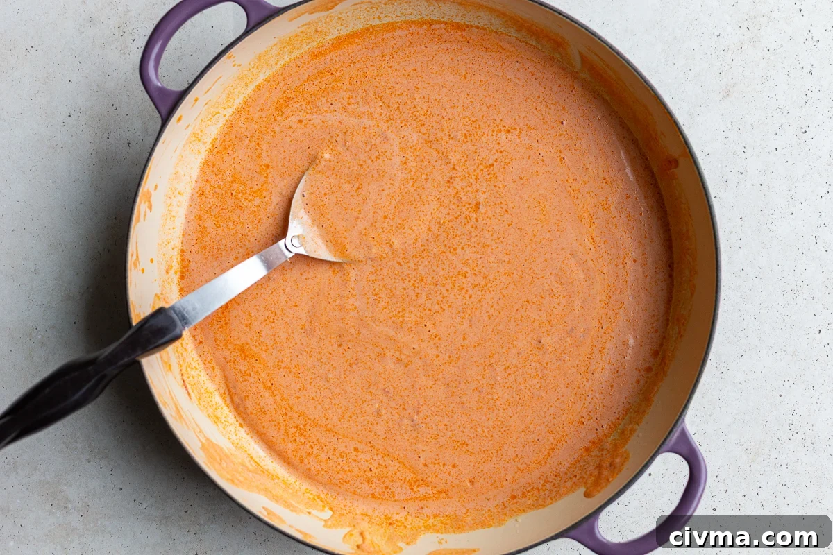 creamy tomato vodka sauce simmering in a skillet