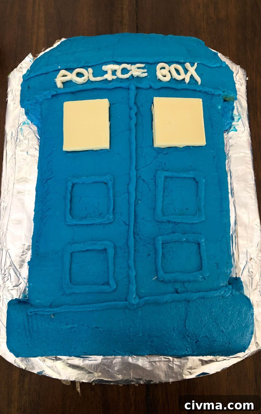 a tardis cake on a foil wrapped cardboard plate