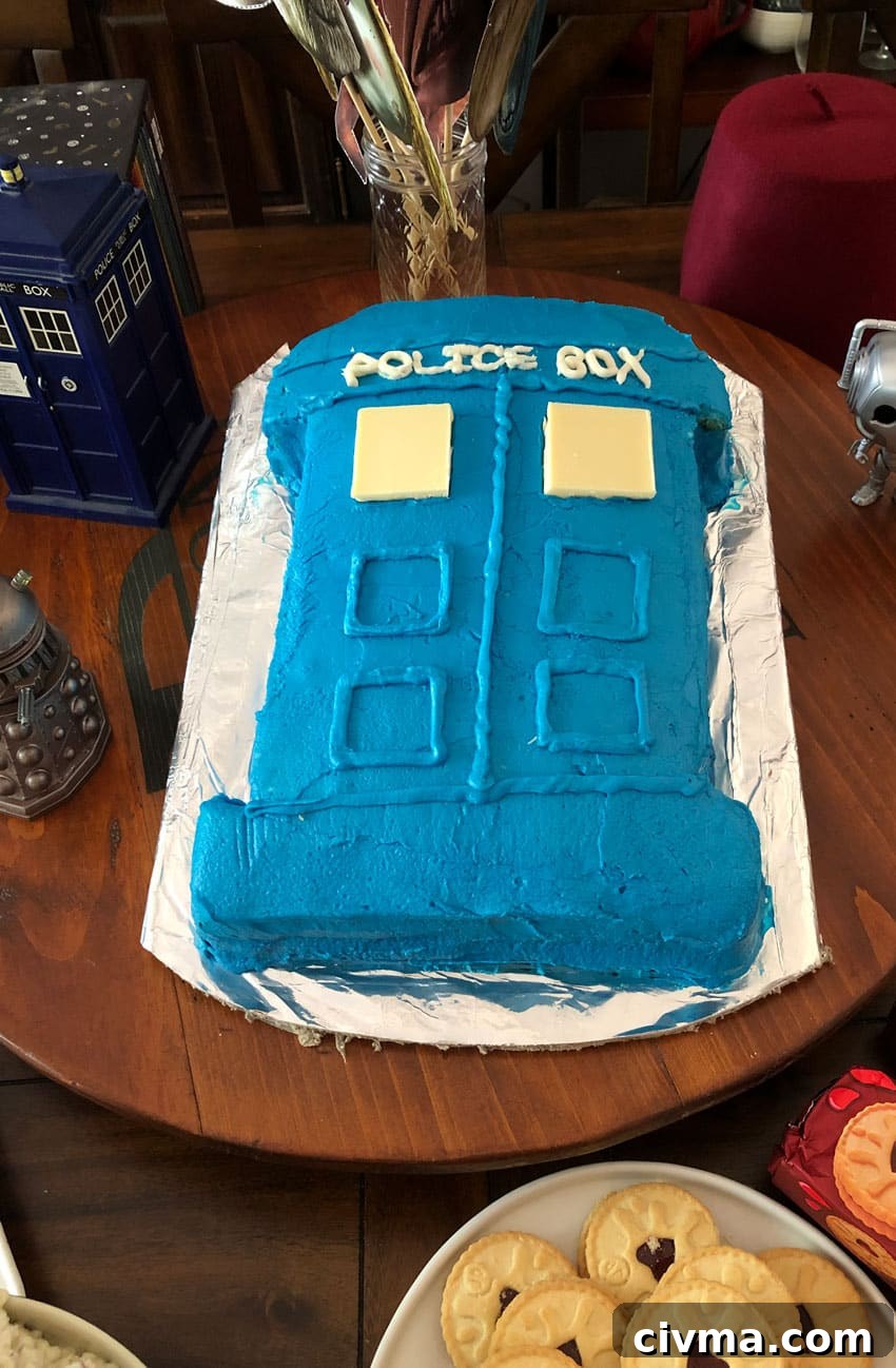 a tardis cake on a foil wrapped cardboard plate