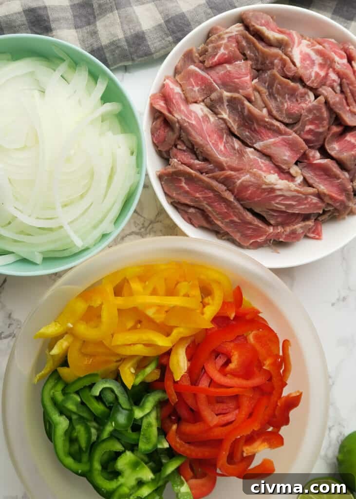 Sliced steak with bell peppers and onions for fajitas