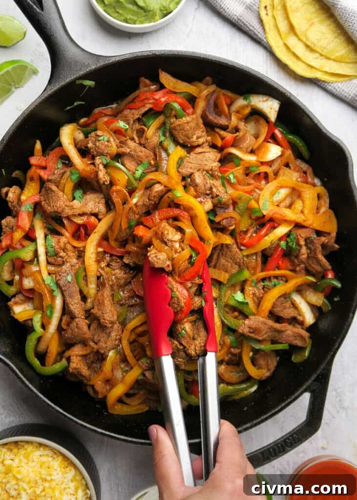 Steak fajitas with tortillas and fresh toppings