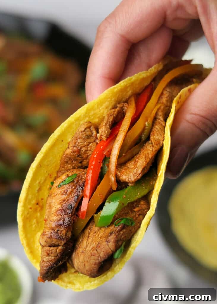 Steak fajitas served with tortillas and toppings