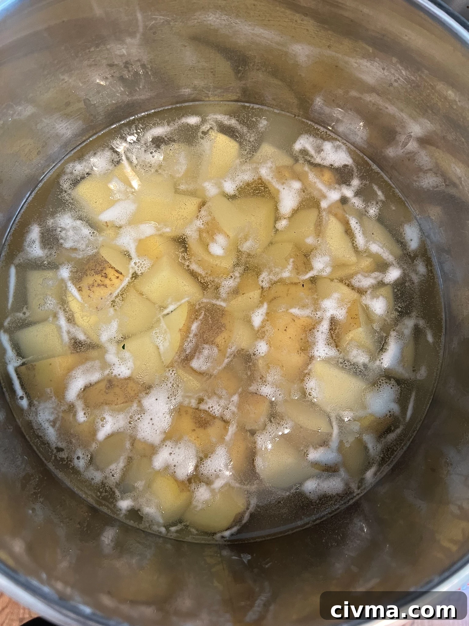 Potatoes boiling in a pot.