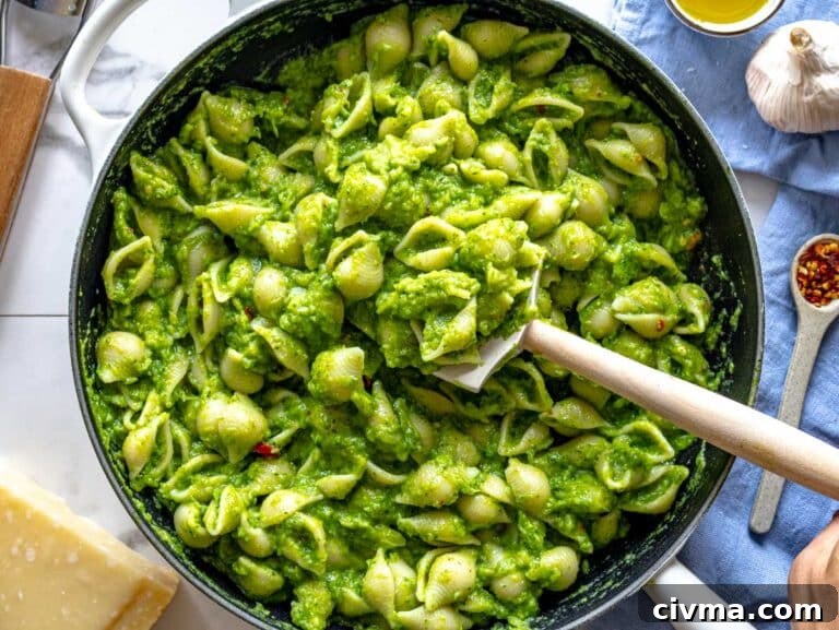 pasta in a skillet mixed with the broccoli sauce