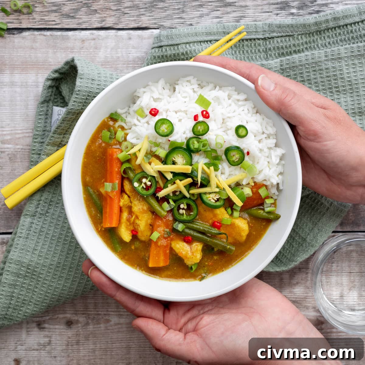 hands holding Chinese chicken curry bowl