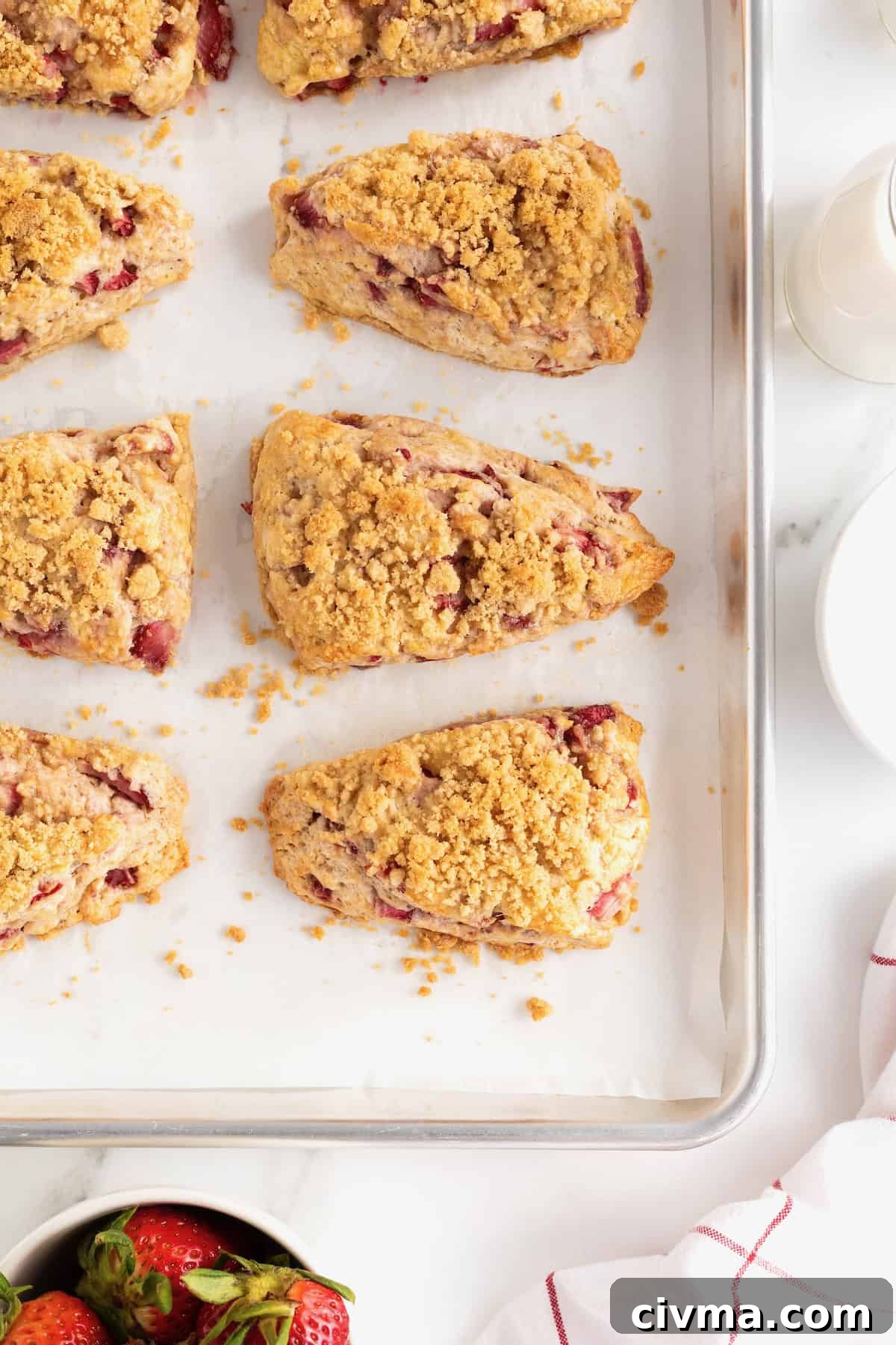Strawberry streusel scones cooling on a baking sheet.