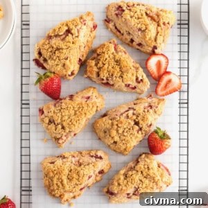 Strawberry streusel scones on a parchment-lined cooling rack.