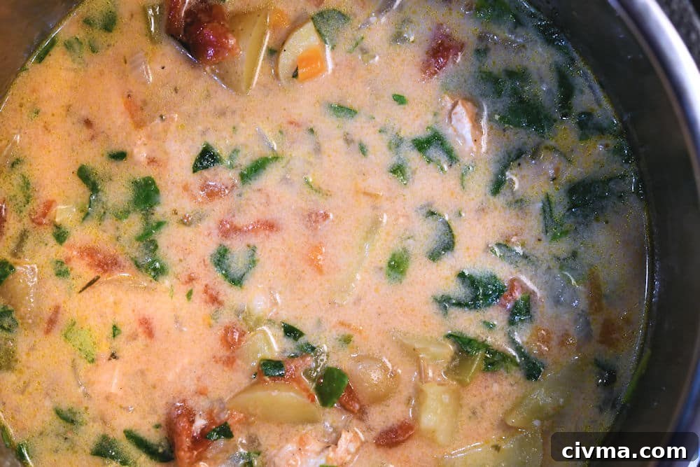 24Bite: Finishing the creamy Tuscan soup with cream and baby spinach