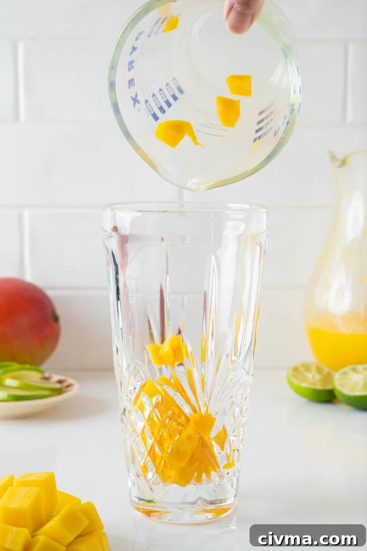 A cocktail shaker with diced mango.