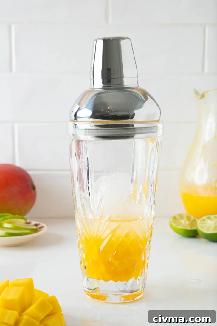 A mango margarita in a cocktail shaker.