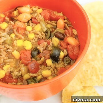 bowl of 7 can taco soup next to tortilla chips.